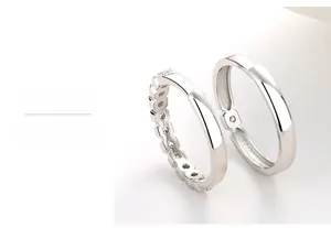 Detail of S925 sterling silver couple rings showing multi-layer polished smooth surface