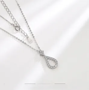 Macro shot of S925 sterling silver teardrop pendant necklace with sparkling pavé zircons