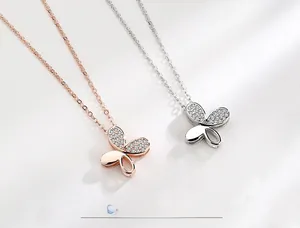 Detail of S925 sterling silver butterfly pendant with pavé cubic zirconia in gold and silver