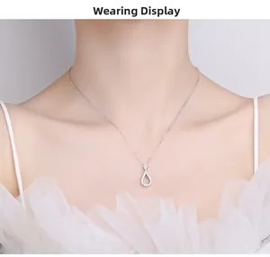 Elegant wearing display of a water drop pendant necklace with pavé set crystals