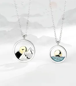 Detail view of S925 silver couple necklaces featuring mountain and sea enamel pendants