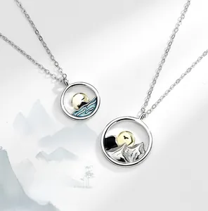 Detail of S925 silver mountain and sea couple necklaces with enamel sun pendants
