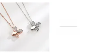 Macro detail of butterfly pendant showing shimmering crystals and polished silver finish