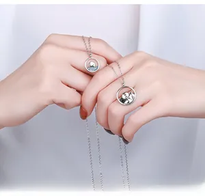 Detailed close-up of S925 sterling silver couple necklaces with sea and mountain motifs