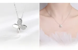 Macro detail of S925 silver butterfly necklace pendant with pavé set cubic zirconia