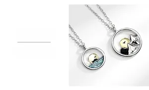 Close-up of S925 sterling silver couple necklaces with sun and moon mountain charms
