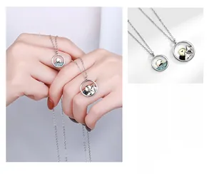 Close-up of S925 silver couple necklaces featuring mountain and sea relief pendants