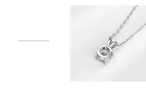 Macro detail of hand-polished four-prong Moissanite pendant on a silver O-chain