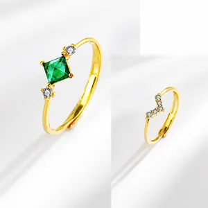 Detail of S925 silver rings with square green emerald and V-shaped diamond band