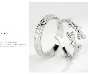 Detail of S925 sterling silver couple rings with branch texture and wavy band
