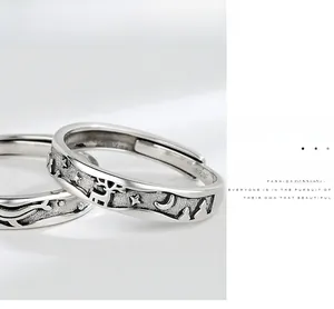 Detail of S925 silver rings with reindeer, forest and stars embossed on aged metal surface