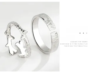 Close-up of S925 silver couple rings featuring branch design and hammered metal texture