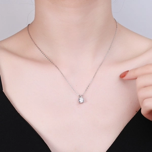 Elegant S925 sterling silver four-prong moissanite pendant necklace on model
