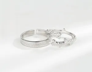 Detailed close-up of S925 sterling silver couple rings with unique wood grain and branch texture
