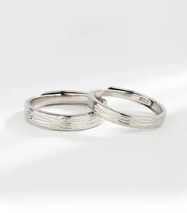 Close-up of S925 sterling silver couple rings featuring unique tree ring texture details