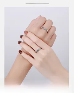 Detail of vintage S925 sterling silver couple rings with whale and deer engravings on fingers