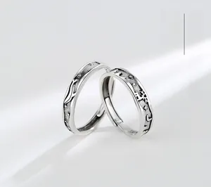 Macro shot of S925 sterling silver couple rings with whale and deer relief carvings