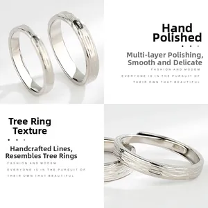 Detail of handcrafted tree ring texture on S925 sterling silver couple rings
