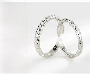 Detail showing S925 hallmark on minimalist hammered texture silver ring band
