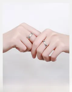 Close-up of S925 sterling silver couple rings with unique annual ring texture on hand