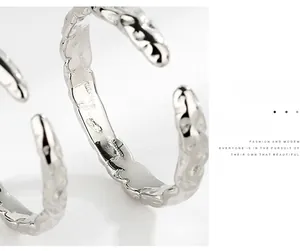 Macro side view of S925 silver ring featuring irregular hammered texture and polished finish