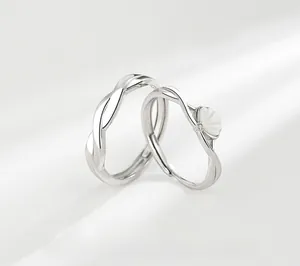Detailed view of sterling silver couple rings with mother-of-pearl inlay and twisted design