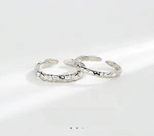 Macro shot of S925 silver rings featuring unique irregular crushed paper texture