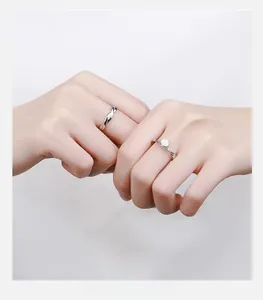 Close-up of sterling silver couple rings with mother of pearl inlay and mobius twist design
