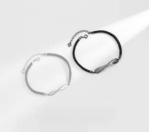 Detailed close-up of S925 sterling silver Mobius infinity bracelets for couples