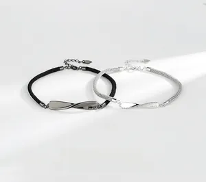 Detail of Mobius infinity bracelets showing the No.52 engraving on silver plates