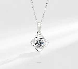 Macro shot of S925 sterling silver four-leaf clover pendant with sparkling moissanite