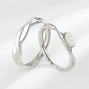Polished silver couple rings set with minimalist twist design and pearl shell accents