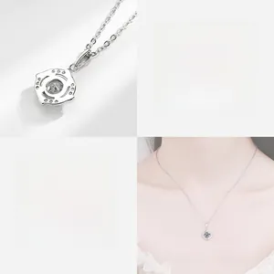 Macro detail of silver windmill pendant with moissanite and adjustable chain necklace