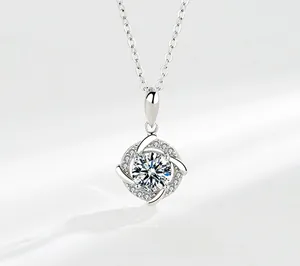Detailed view of windmill moissanite pendant on silver chain with brilliant fire and sparkle