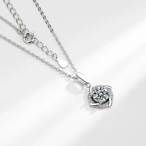 Silver windmill pendant necklace with moissanite and twisting brilliant stone accents