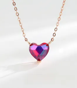 Detail of rose gold heart pendant with faceted gradient purple crystal on link chain