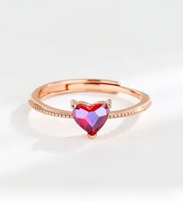 Detail of S925 sterling silver heart-shaped red gemstone ring with beaded rose gold band