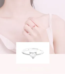 Detail of adjustable heart ring with pavé settings in rose gold and silver finishes