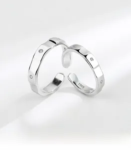 Macro detail of S925 sterling silver couple rings with geometric facets and zircon stones