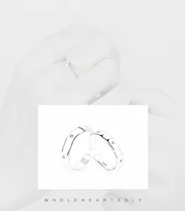 Detail of S925 sterling silver couple rings with small stones and S925 engraving