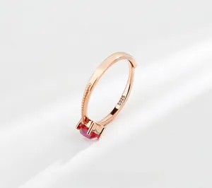 Detail view of S925 sterling silver stamp on rose gold ring with red octagon gemstone