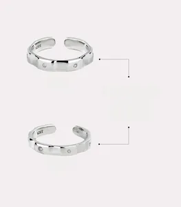 Detail of S925 sterling silver couple rings with geometric facets and zircon stones