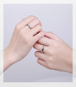 Macro detail of S925 silver couple rings featuring cute black and white cat and moon patterns