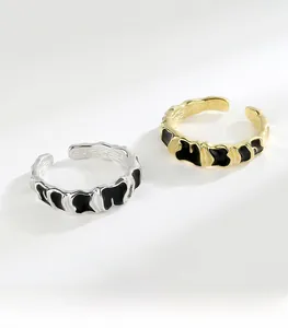 Detailed macro view showing the S925 hallmark on irregular enamel silver and gold rings