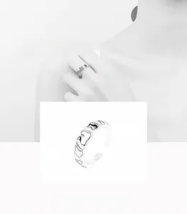 Macro detail of silver irregular textured ring band with minimalist geometric wavy design