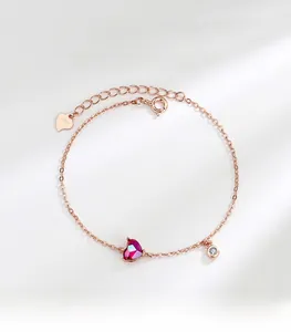 Detail of rose gold S925 silver bracelet featuring a red heart-shaped gemstone pendant