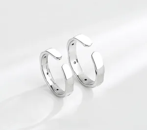 Close-up of minimalist S925 sterling silver adjustable couple rings with polished finish