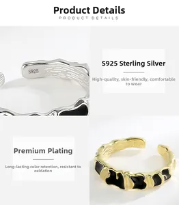 Detailed macro view of S925 sterling silver ring with black enamel and wavy golden texture
