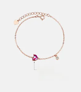 Macro shot of S925 sterling silver tag and adjustable chain on a rose gold heart bracelet