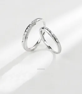 Detailed view of S925 sterling silver rings with mountain and wave textured engravings